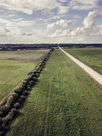 Aerial Photo of Agriculture Fields with Dramatic Skies over them in Early Spring on Sunny Day - Concept of Peaceful Life in Countryside in Harmony, Vintage Film Lookの写真素材