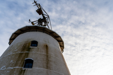 Closeup of Old Abandoned Windmill with Blue Skies in Background in Winter - Concept of Fun and Joyの写真素材