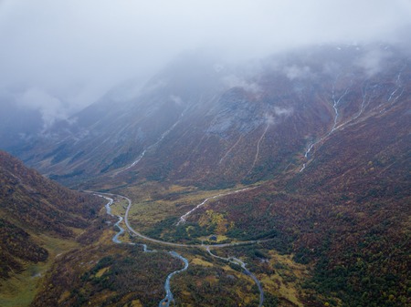 Drone Photo of Several Small Waterfalls in Mountains with Clouds Covering them Near BÃ¸jabreen...