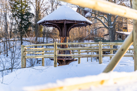 Snowy Photo of the Park on a Sunny Winter day - Wooden Footpath in the Middle of it, Concept of the Harmony and Travel in the Countrysideの写真素材