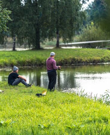 Blome / Latvia - August 20th, 2018: Photo of Two Millennials Fishing - Spending Quality Leisure Timeのeditorial素材