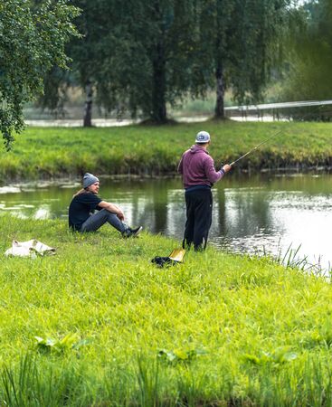 Blome / Latvia - August 20th, 2018: Photo of Two Millennials Fishing - Spending Quality Leisure Timeのeditorial素材