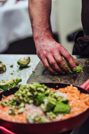Male Chef Slicing Avocado for Wedding Meal - Kitchen Set with Isolated Action, Only Chef`s Hands, Vintage Film Lookの写真素材