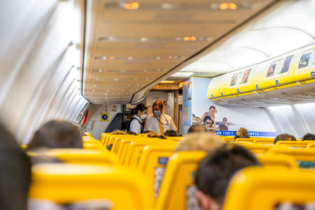 Malaga / Spain - August 15th, 2020: cabin crew wearing face masks inside planeのeditorial素材