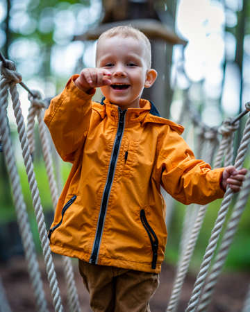 Young happy child in playground obstacle course - close up portrait