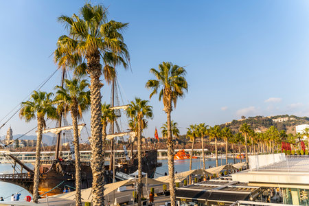 Malaga, Spain 10th of January, 2020: Black Pirate Ship on Port behind Palm Treesのeditorial素材