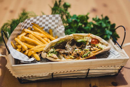 Open Beef Kebab with fries and some greens in Basket, Copy Space on Top - Selective Focusの写真素材