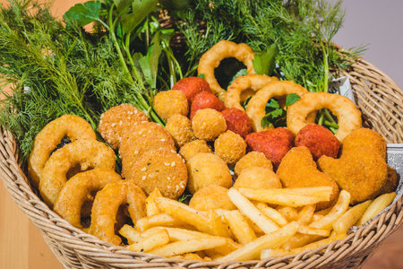 Fast Food Snack Basket with Onion Rings and Falafel - Closeup with Parsley and Dillsの写真素材
