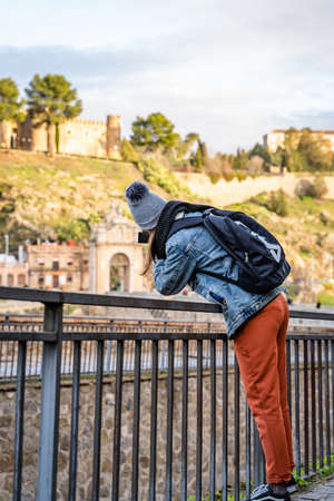 Toledo / Spain - January 23rd, 2020 Happy Solo Traveler Taking Photo of Castillo San Servando castleのeditorial素材
