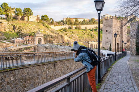 Toledo / Spain - January 23rd, 2020 Happy Solo Traveler Taking Photo of Castillo San Servando castleのeditorial素材