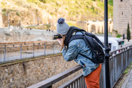 Toledo / Spain - January 23rd, 2020 Happy Solo Traveler Taking Photo of Castillo San Servando castleのeditorial素材