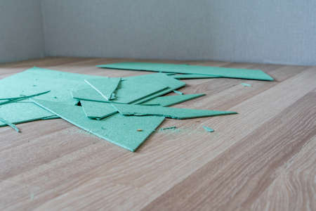 Laminate Underlayment Pieces Lying on Floor, DIY project Room Remodeling and Reconstruction - Selective Focusの写真素材