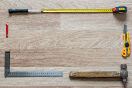 Frame from Worker's Tools on Wooden Background, Empty Space For Text, Poster Background with Copy Space in Middleの写真素材