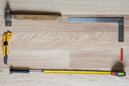 Frame from Worker's Tools on Wooden Background, Empty Space For Text, Poster Background with Copy Space in Middleの写真素材