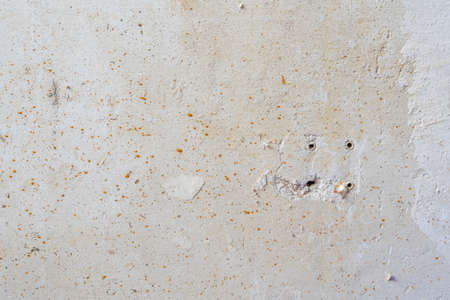 Drilled Holes in White Scratched Concrete Wall Room reconstruction Process with Copy Spaceの写真素材