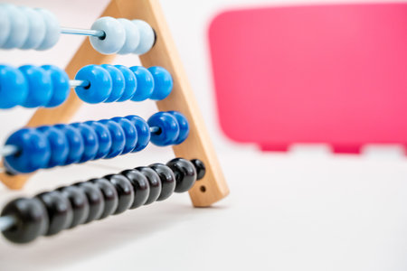 Colorful Abacus Close Up on White and Pink Background with Copy Space, Concept of Finances and Business. Arithmetical and Mathematical Learning Toyの写真素材