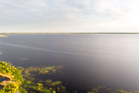 Cloudy Sky Background, Drone View Over Lake's Coastline with Copy Space on Sunny Summer Evening