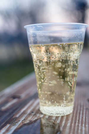 Sparkling Champagne in Plastic Cup, Concept of Alcoholism and Lonelinessの写真素材