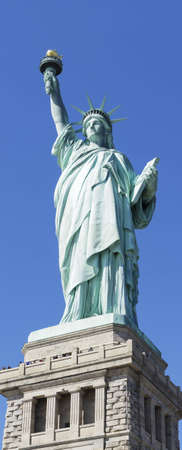 Statue of Liberty in New York set against a clear blue skyの写真素材