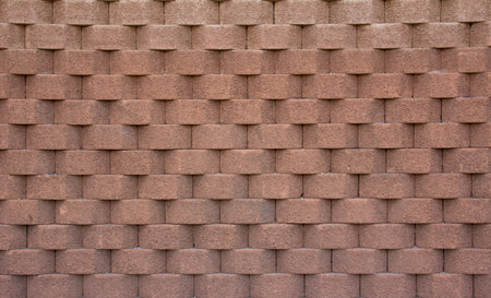 Brick wall with light brown geometric shapes. Feeling of depth. Texture. Background.