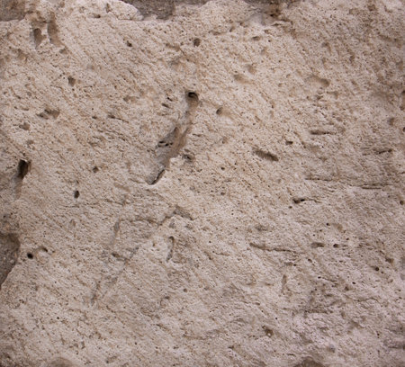 Stone texture in beige with holes. Background.の写真素材