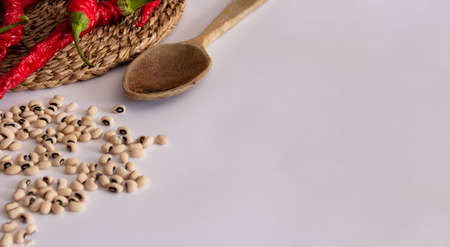Red peppers on wicker surface, wooden ladle, dried pumpkin and beans. Mediterranean food. Top view. Flat lay. Copy space.の写真素材