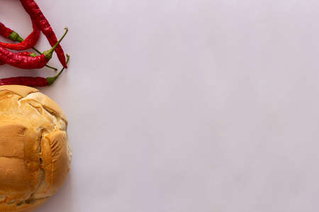 Set of rural bread and thin red peppers on white background. Top view. Flat lay. Copy space.の写真素材