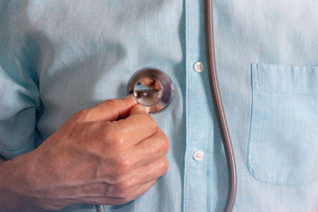 Health care concept with person listening to himself. Stethoscope. Copy space. Selective focus.の写真素材