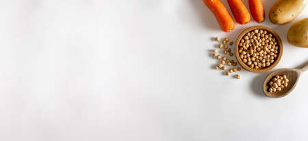 Natural ingredients. Carrots, potatoes and chickpeas. Mediterranean food. Flat lay. Copy space.の写真素材
