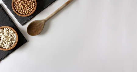 Natural ingredients. Chickpeas and beans on slate surface. Flat lay. Copy space.の写真素材