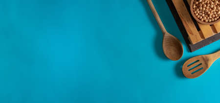 Cork bowl with chickpeas and wooden cutlery. Flat lay. Copy space.の写真素材