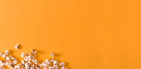 Popcorn on yellow background. Flat lay. Copy space. Movie time.の写真素材