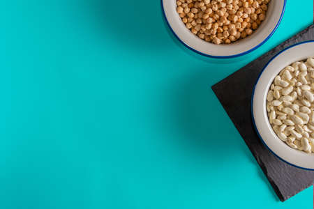 Background with bowls with chickpeas and beans. Flat lay. Copy space.