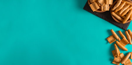 Different types of crusty breads on blue background. Flat lay. Copy space. Snackの写真素材