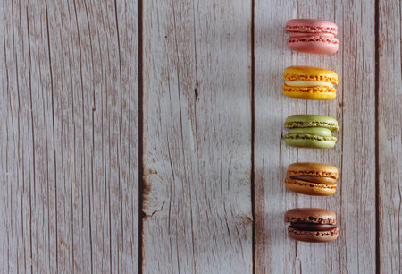 Dessert of French macarons in pastel colors on wood. Copy space. Selective focus.の写真素材