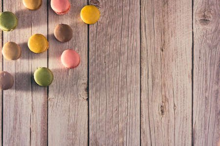 Dessert of French macarons in pastel colors on wood. Copy space. Selective focus.の写真素材