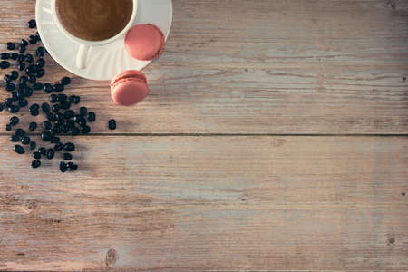 French macarons dessert with coffee cup and coffee beans. Copy space. Selective focus.の写真素材
