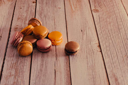 Dessert of French macarons in pastel colors on wood. Copy space. Selective focus.の写真素材