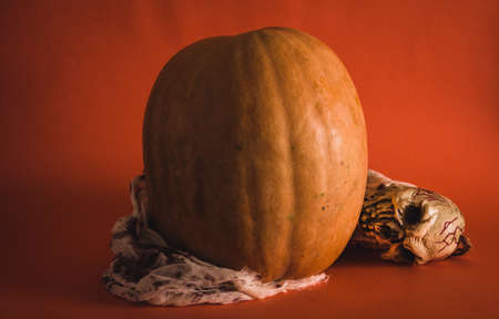 Pumpkin surrounded by skeleton with blood. Halloween. Selective focus. Copy space.の写真素材