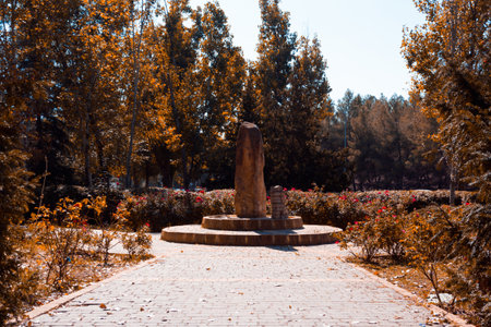 Stone monolith in the park on an autumn day. Copy space.  Selective focus.の写真素材