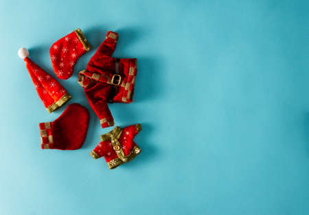 Decorative Christmas clothes on blue background. Copy space. Selective focus.