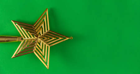 Christmas star on green background. Copy space. Selective focus.