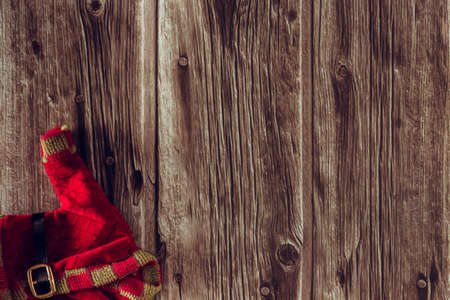 Decorative Christmas elf clothes on wooden background. Copy space. Selective focus.