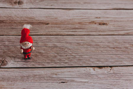 Christmas decorative elf on wooden background. Copy space. Selective focus.の写真素材