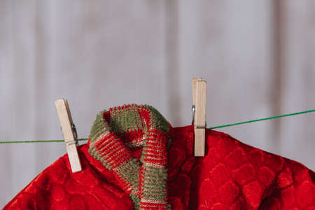 Christmas elf clothes hung with clothespins. Copy space. Selective focus.の写真素材