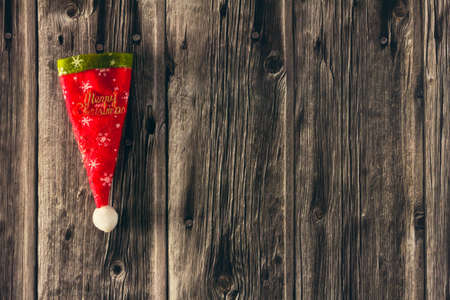 Decorative Christmas hat on wooden background. Copy space. Selective focus.の写真素材
