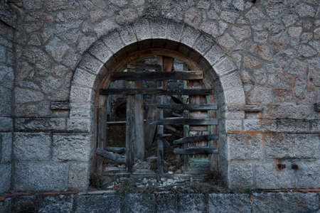 Old stone and wood window, crumbling and broken. Selective focus.の写真素材