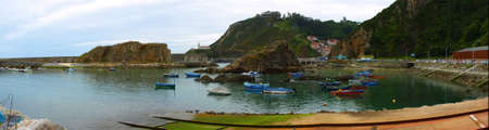 Small fishing port with rocks and boats in northern Spain. Copy space. Selective focus.の写真素材