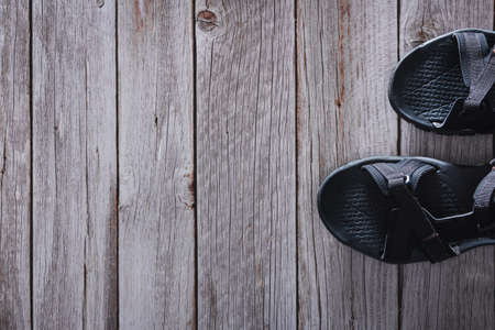 Summer sport sandals on wooden bottom. Accessory. Copyspace. Selective focus.