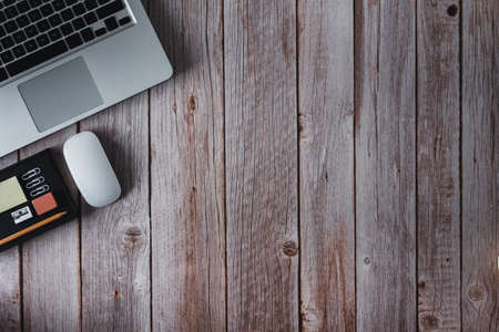 Workspace with laptop, notebook and glasses on wooden background. Topview. Copy space. Selective focus.の写真素材